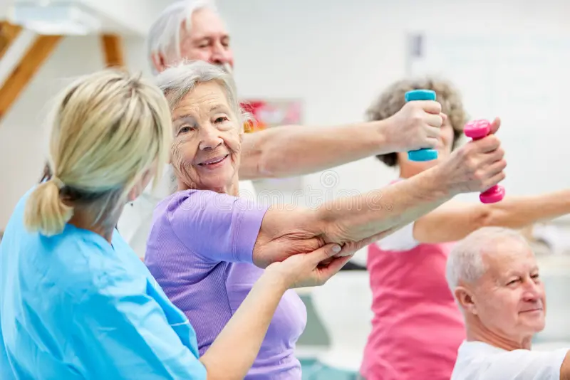 females sitting in wheelchairs doing neurologic rehab exercises